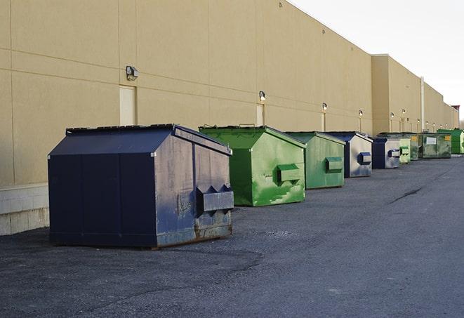 tilted front-load dumpsters being emptied by waste management workers in Arlington